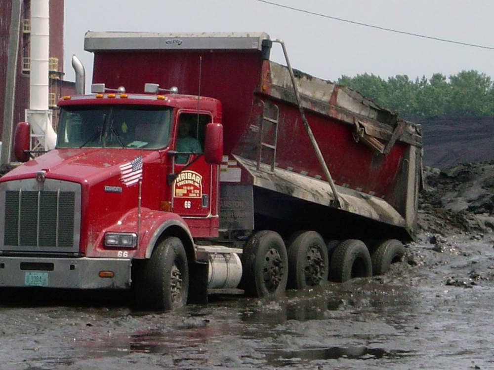 Hribar Logistics dump truck driving through mud
